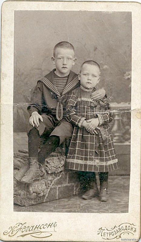 Мальчик в «матросском» костюме и стриженая девочка в клетчатом платье