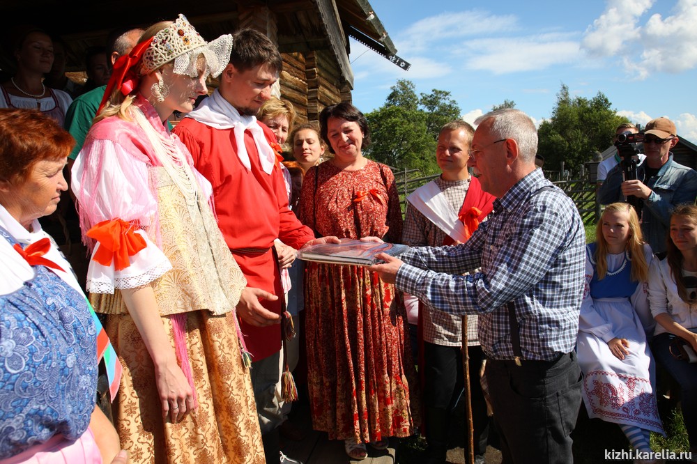 Директор музея А.В. Нелидов вручает участникам традиционного заонежского свадебного обряда памятный подарок