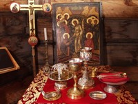 The Eucharist is performed on a consecrated credence table and holy table covered with cloth. Vessels and items necessary for the liturgy are placed on the tables. Gradually in addition to the items enlisted above some others appeared in the alter: an icon and a lantern to be carried out, and icons 